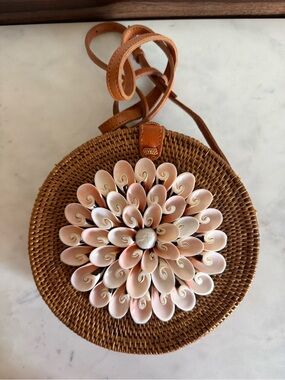 Round Woven Crossbody Bag with Pink Shell Flower Accent